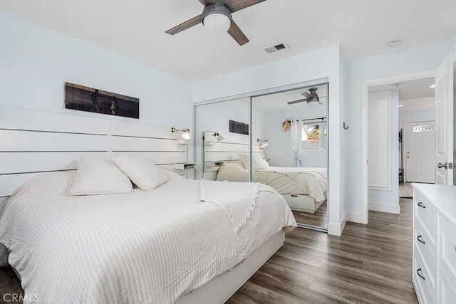 bedroom with dark hardwood / wood-style floors, ceiling fan, and a closet