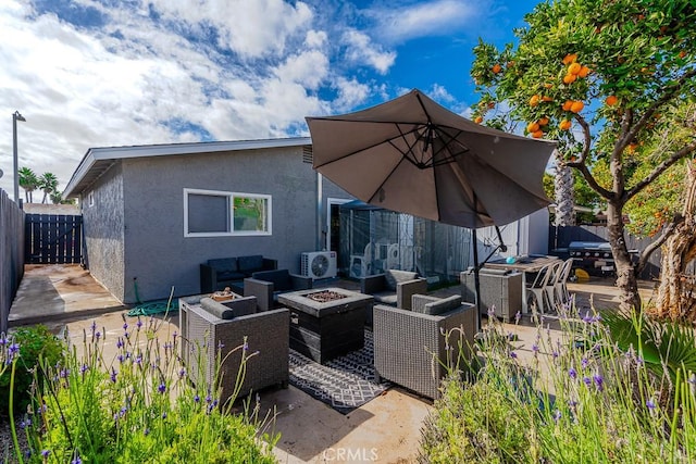 view of patio / terrace featuring ac unit and an outdoor living space with a fire pit