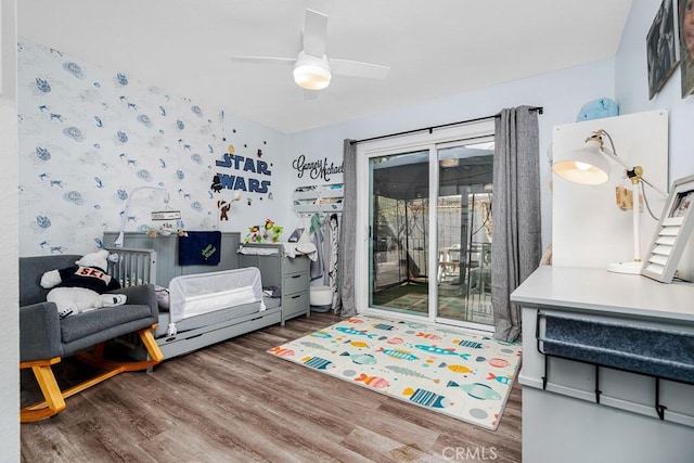 interior space with hardwood / wood-style floors, access to outside, and ceiling fan