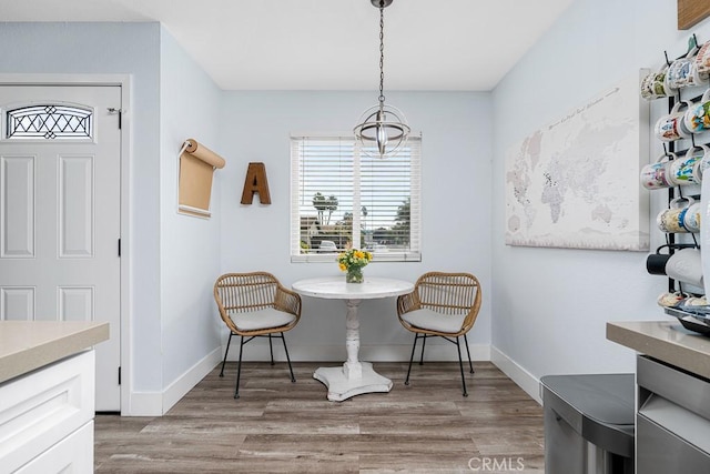 dining room with light hardwood / wood-style flooring and a healthy amount of sunlight