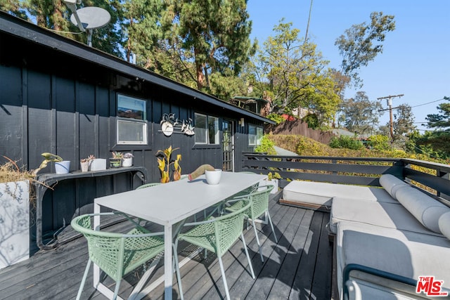 wooden terrace with outdoor lounge area