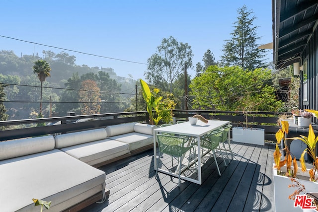 wooden deck with outdoor lounge area