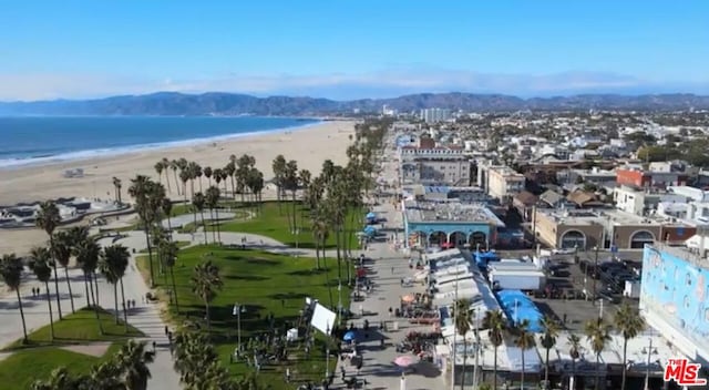 aerial view with a water view and a view of the beach