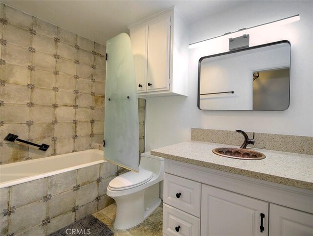 full bathroom featuring vanity, toilet, and tiled shower / bath combo