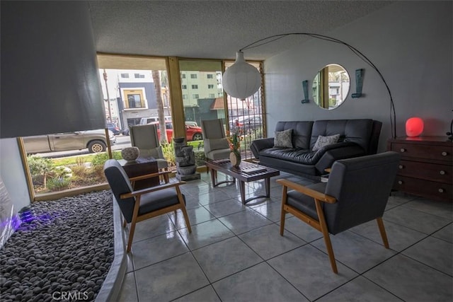 tiled living room with a textured ceiling and a wall of windows