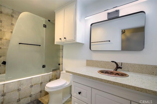 bathroom featuring tiled shower / bath combo, toilet, and vanity