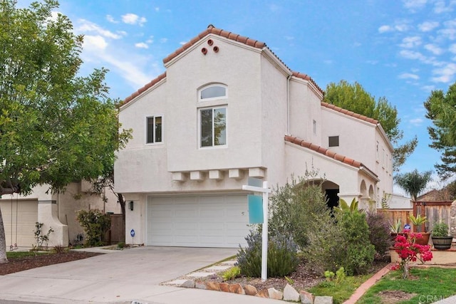 mediterranean / spanish-style house with a garage