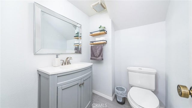 bathroom with vanity, tile patterned floors, and toilet