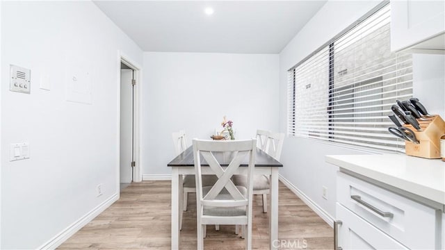 dining area with light hardwood / wood-style floors