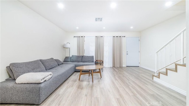 living room with light hardwood / wood-style flooring