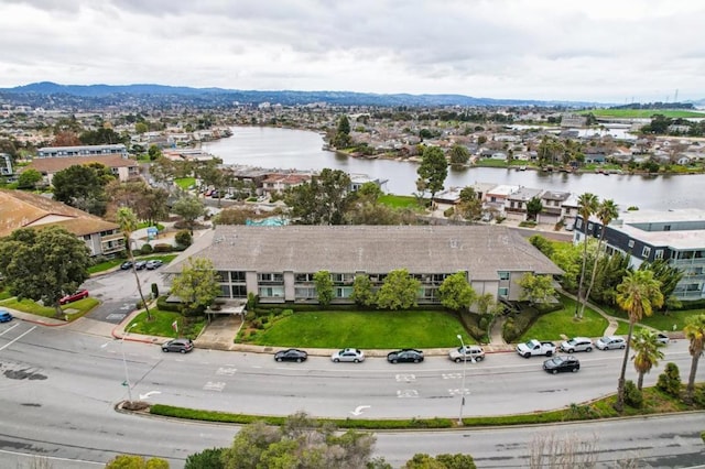 drone / aerial view featuring a water and mountain view