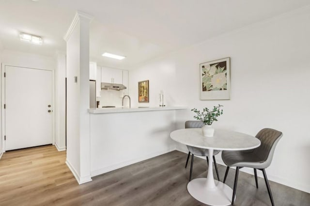 dining room featuring hardwood / wood-style floors and sink