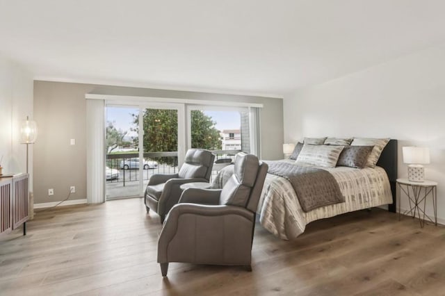 bedroom featuring hardwood / wood-style flooring and access to exterior