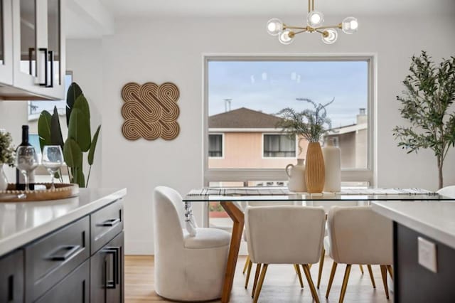 dining room with an inviting chandelier and light hardwood / wood-style flooring