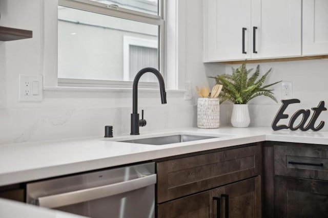 details with dark brown cabinetry, dishwasher, sink, and white cabinets