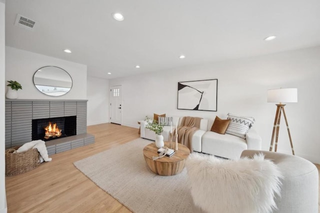 living room featuring light hardwood / wood-style flooring and a fireplace