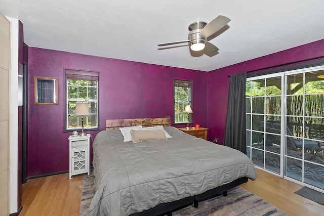 bedroom with ceiling fan, hardwood / wood-style floors, and access to outside