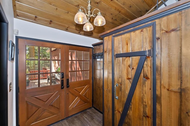 doorway featuring an inviting chandelier, wood ceiling, dark hardwood / wood-style flooring, and french doors