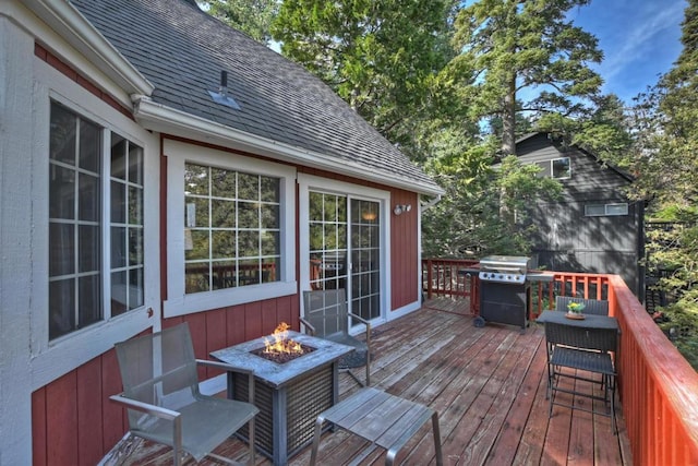 deck featuring grilling area and a fire pit