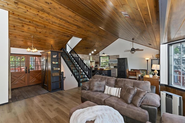 living room featuring a healthy amount of sunlight, radiator heating unit, and wooden ceiling