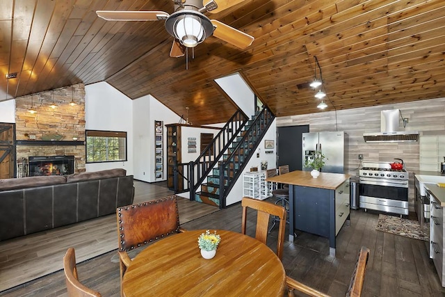 dining space with a fireplace, dark hardwood / wood-style floors, and wooden ceiling