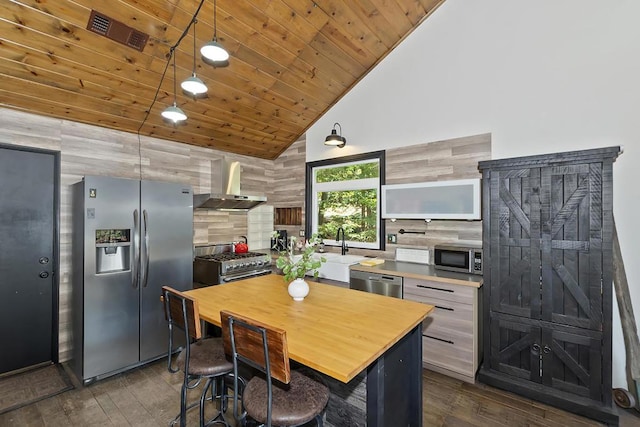 kitchen with dark wood-type flooring, wall chimney exhaust hood, wood ceiling, appliances with stainless steel finishes, and backsplash