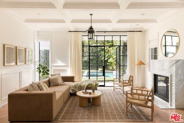 living room with beamed ceiling, a premium fireplace, wood-type flooring, and coffered ceiling