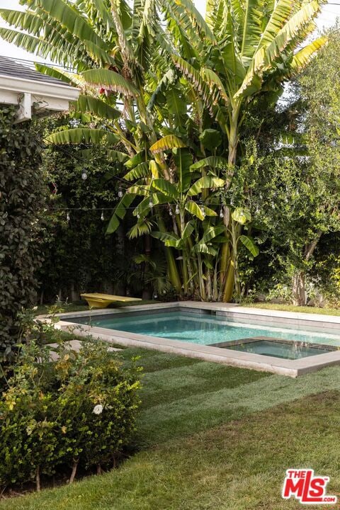 view of pool featuring a lawn