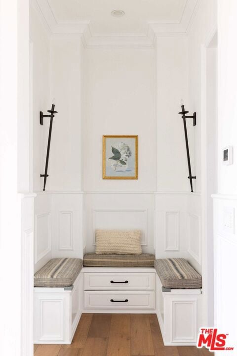 mudroom with crown molding and light hardwood / wood-style flooring