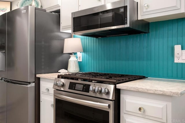 kitchen with white cabinetry and appliances with stainless steel finishes