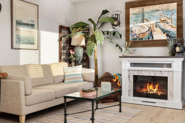 sitting room featuring hardwood / wood-style flooring and a high end fireplace