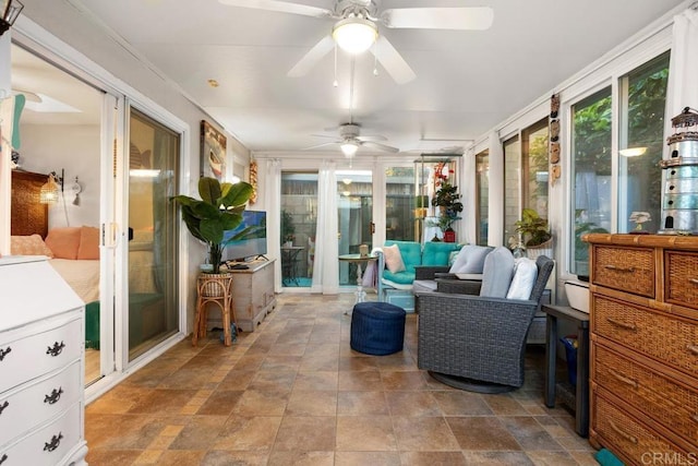 sunroom featuring ceiling fan