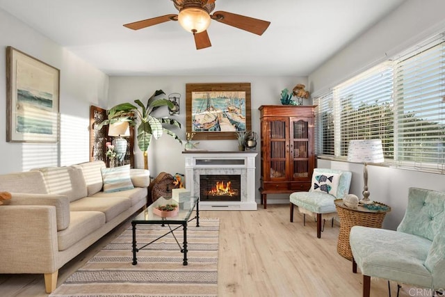 living room featuring ceiling fan and light hardwood / wood-style flooring