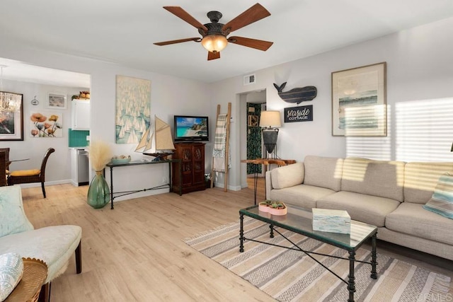 living room featuring ceiling fan and light wood-type flooring