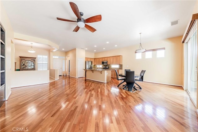 9431 Hughes Dr, Corona, CA 92883 - living room featuring recessed lighting, visible vents, plenty of natural light, and light wood-style flooring
