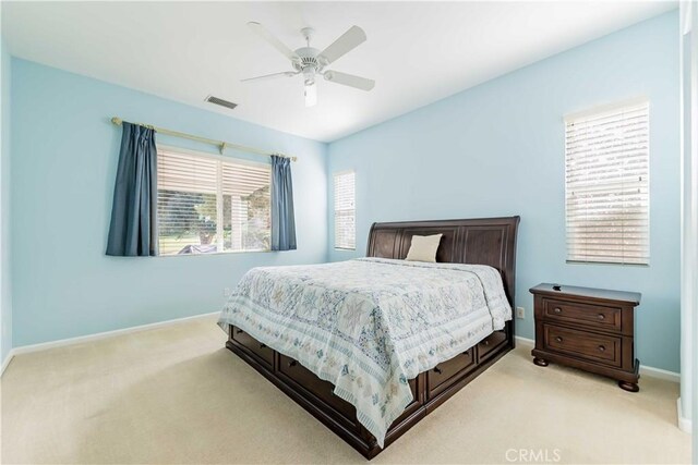 9431 Hughes Dr, Corona, CA 92883 - bedroom featuring light carpet, baseboards, visible vents, and a ceiling fan