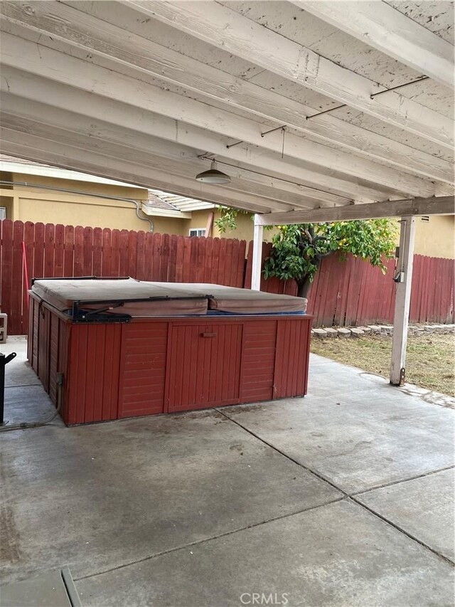 view of patio / terrace with a hot tub