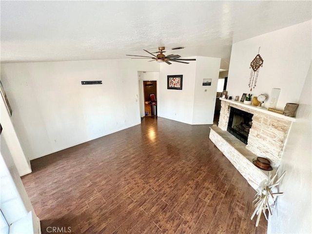 unfurnished living room featuring dark wood-type flooring, a fireplace, and ceiling fan