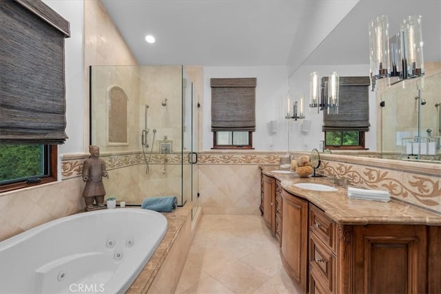 bathroom with tile patterned flooring, vanity, separate shower and tub, and tile walls