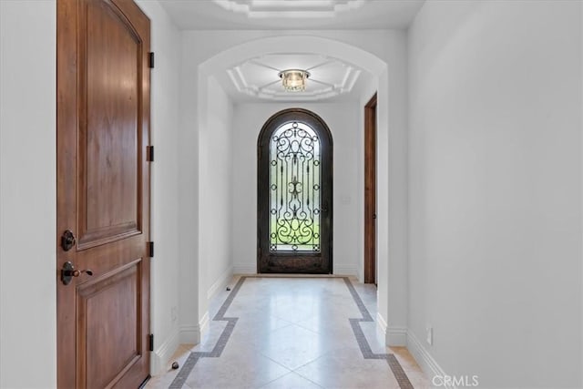 entrance foyer with a raised ceiling