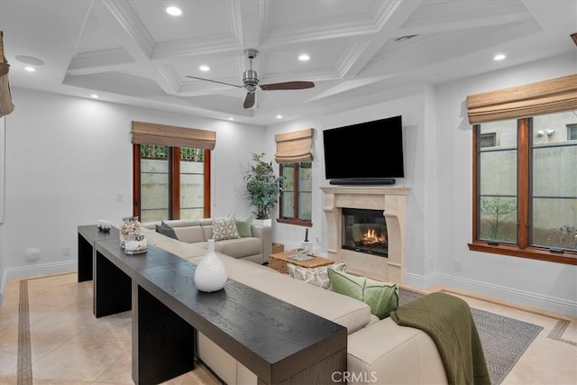 tiled living room with a premium fireplace, ceiling fan, beam ceiling, coffered ceiling, and ornamental molding