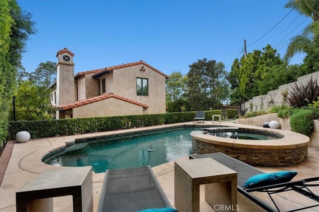 view of swimming pool featuring an in ground hot tub