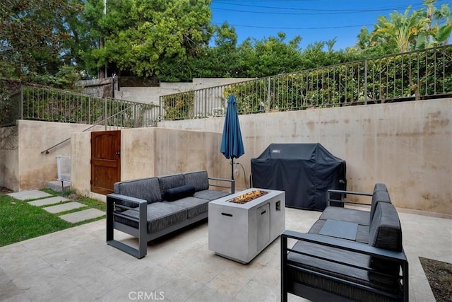 view of patio featuring a grill and an outdoor living space with a fire pit