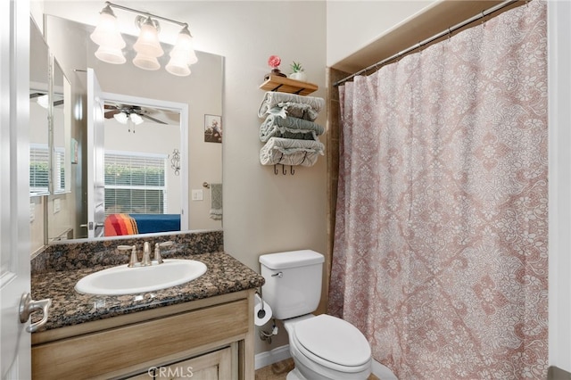 bathroom featuring ceiling fan, vanity, and toilet