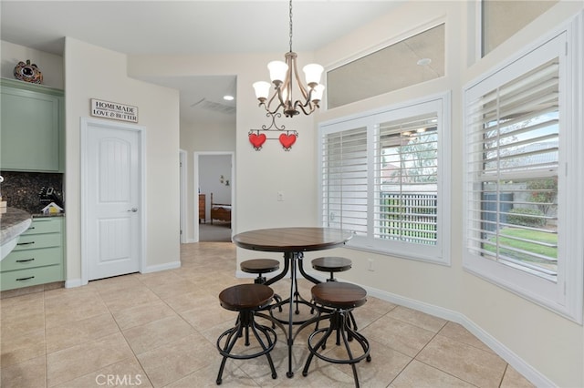 tiled dining area with an inviting chandelier