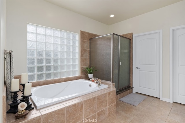 bathroom featuring tile patterned flooring and plus walk in shower