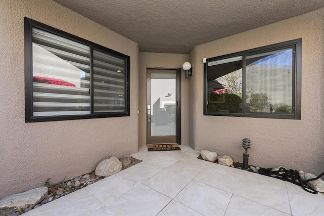 entrance to property featuring a patio area