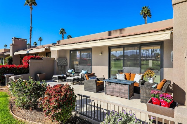 back of house with an outdoor living space and a patio area