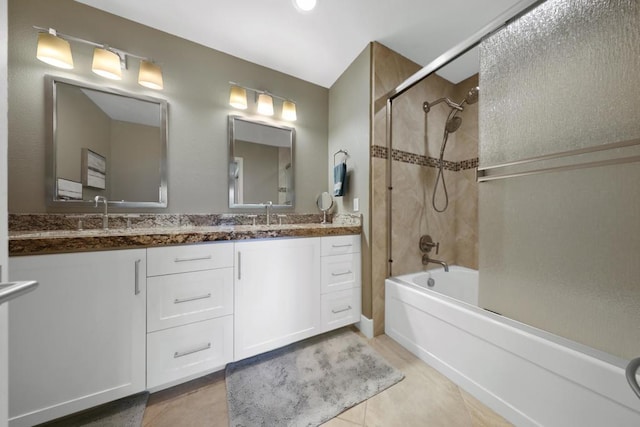 bathroom with vanity, tiled shower / bath combo, and tile patterned floors