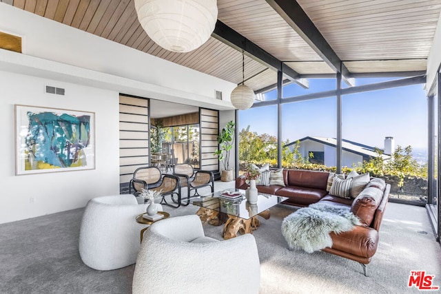 sunroom featuring lofted ceiling with beams and wooden ceiling